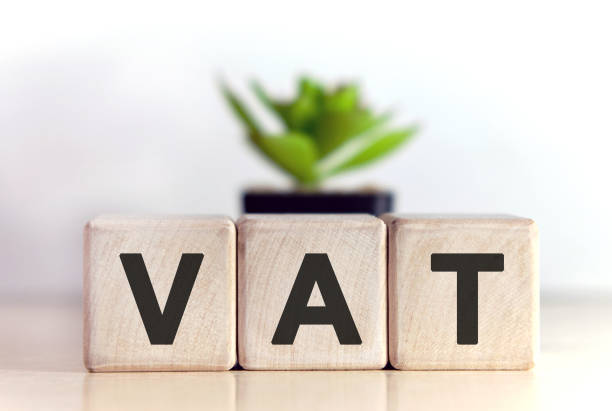 Home vat concept on wooden cubes and flower in a pot in the background